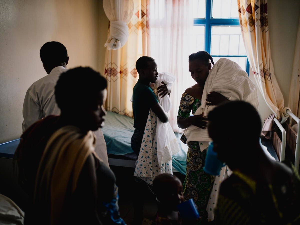 Therese*, a refugee from the Democratic Republic of Congo, brings her twins babies Gloria* and Gildas* to a medical centre in Mahama refugee camp, Rwanda
