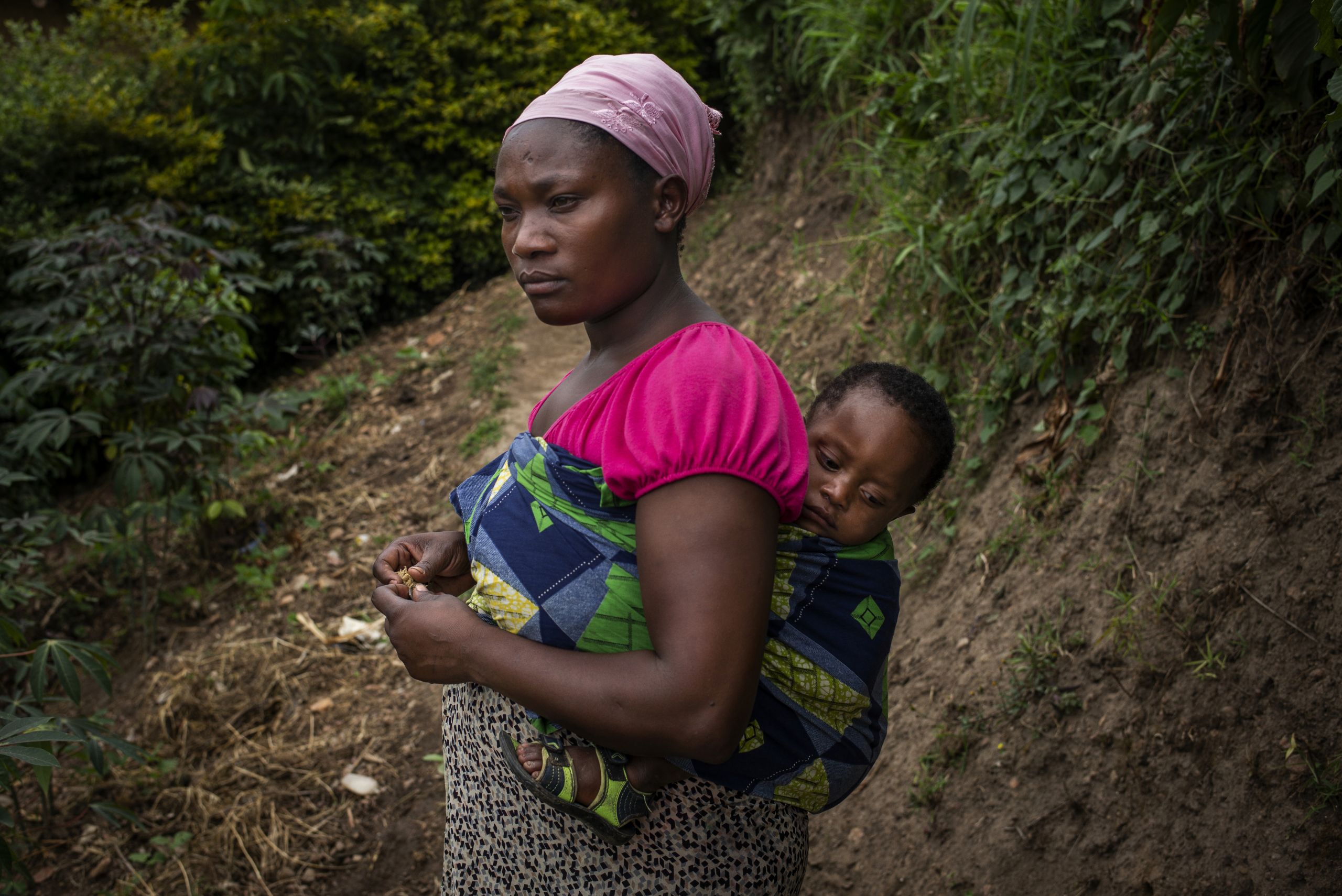 Vanessa Ntakirutimana with her one and a half year old son on the path to her village.