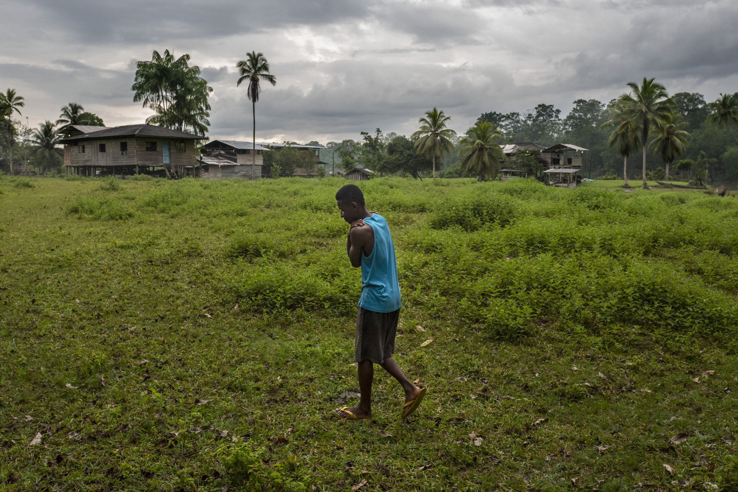 José David Rios* (Name changed), 17, walks in a village which is similar to the one where he grew up.