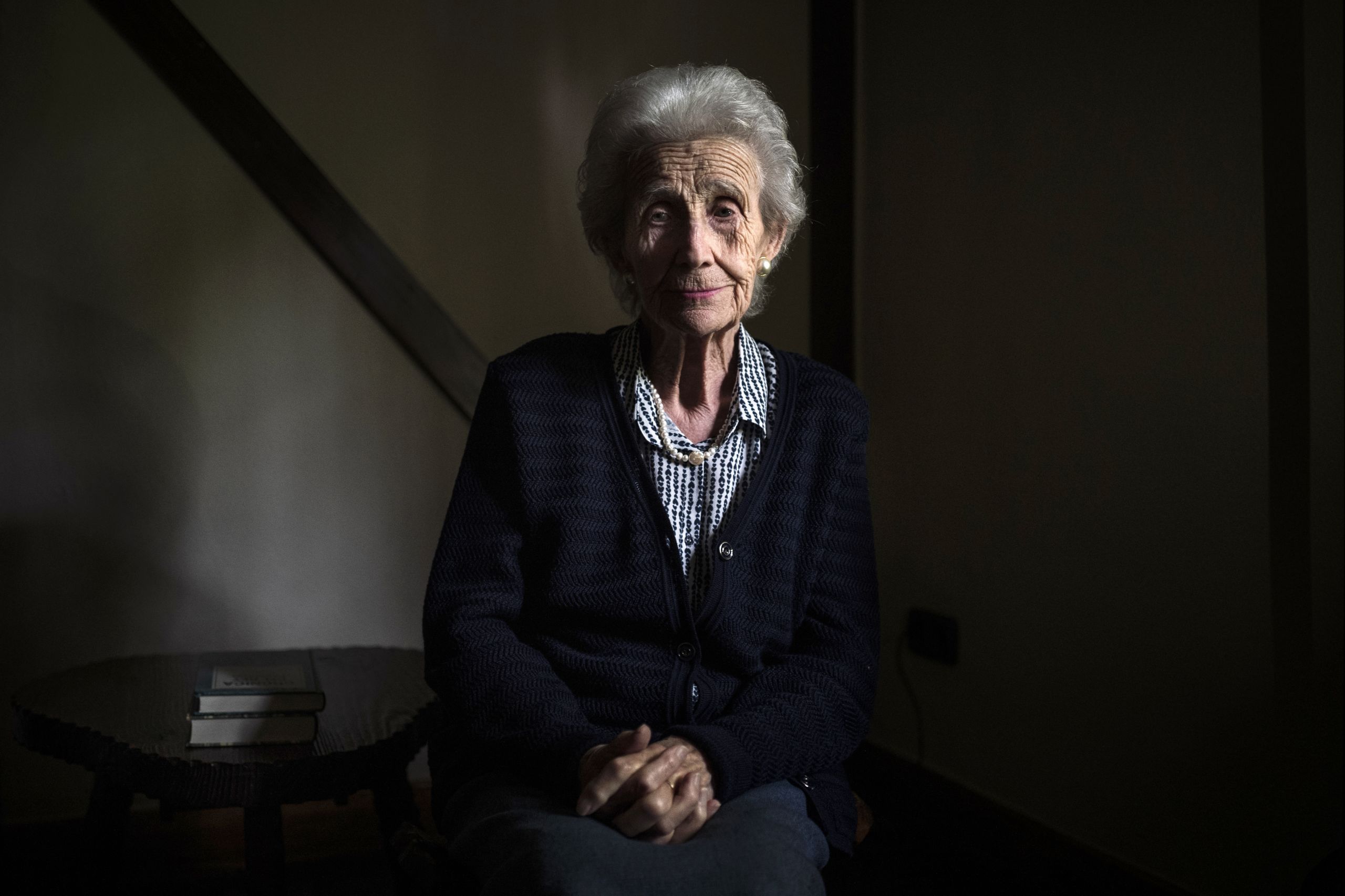 91 year old María Consuelo Beltrán sitting for a portrait inside an old hotel in Irun.