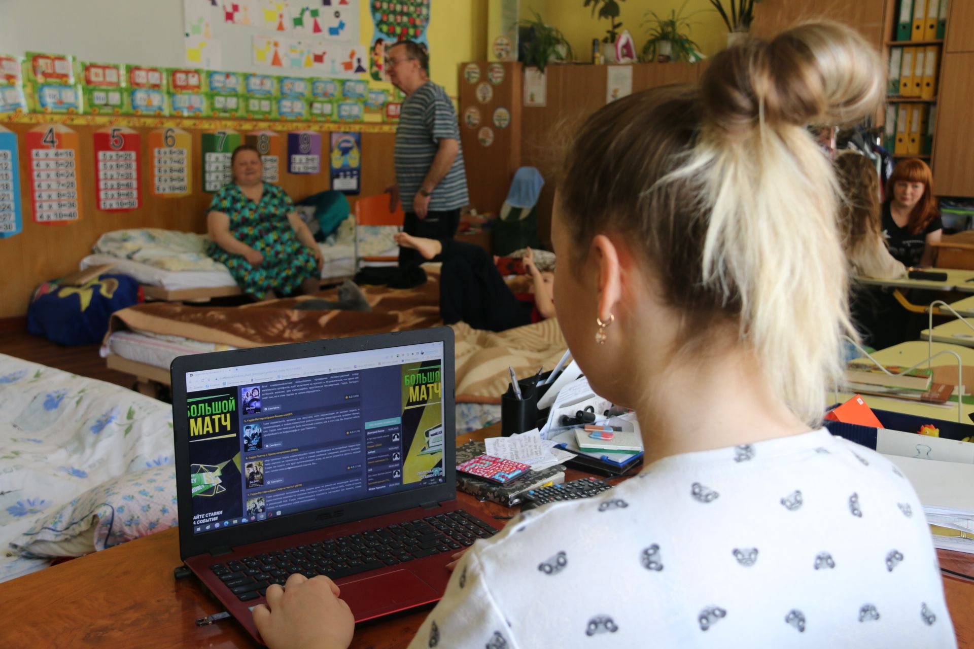 Mariia*, 13 at her computer in the classroom where she is living